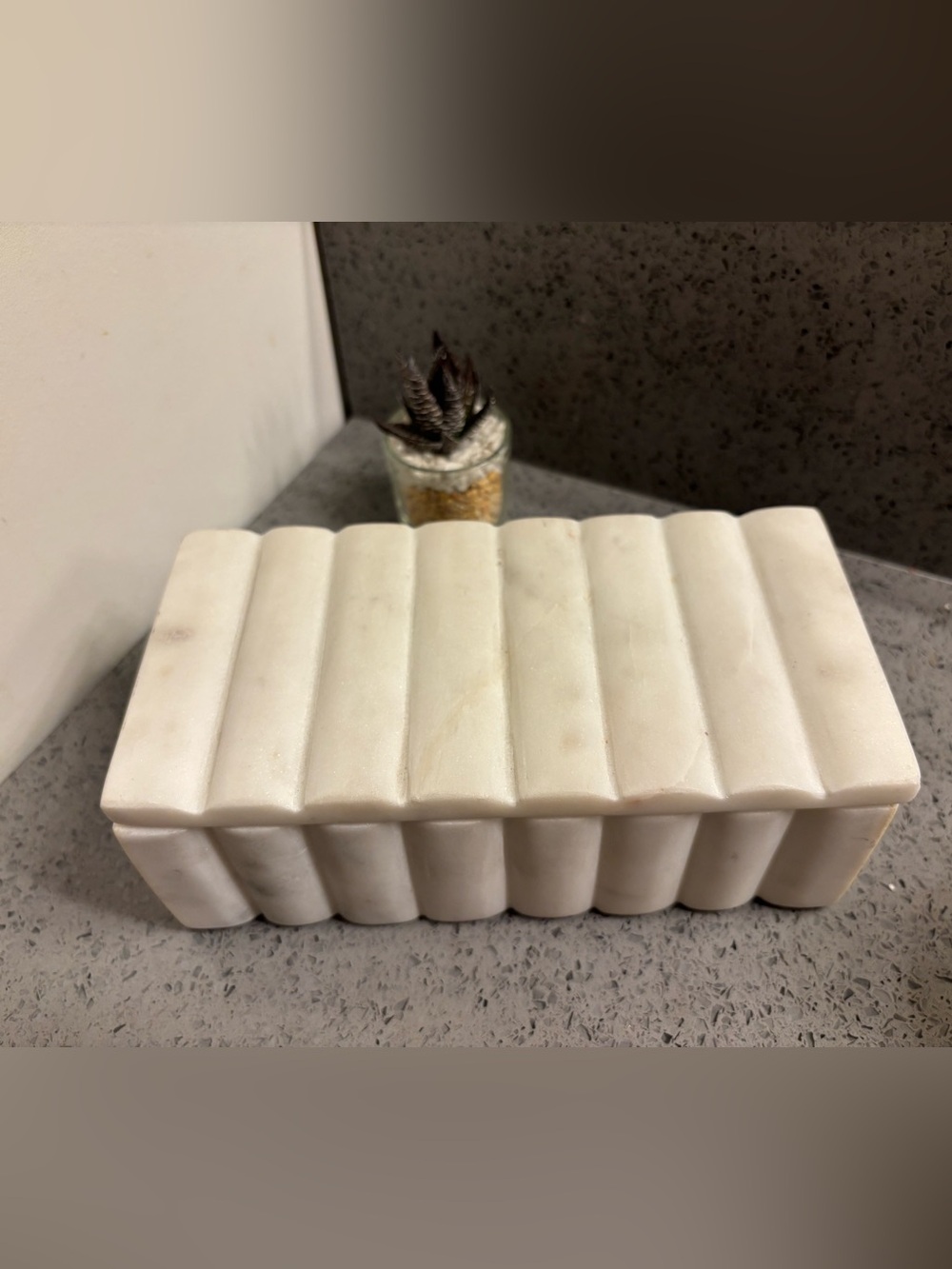 White marble decorative storage box featuring a ridged, with lid.